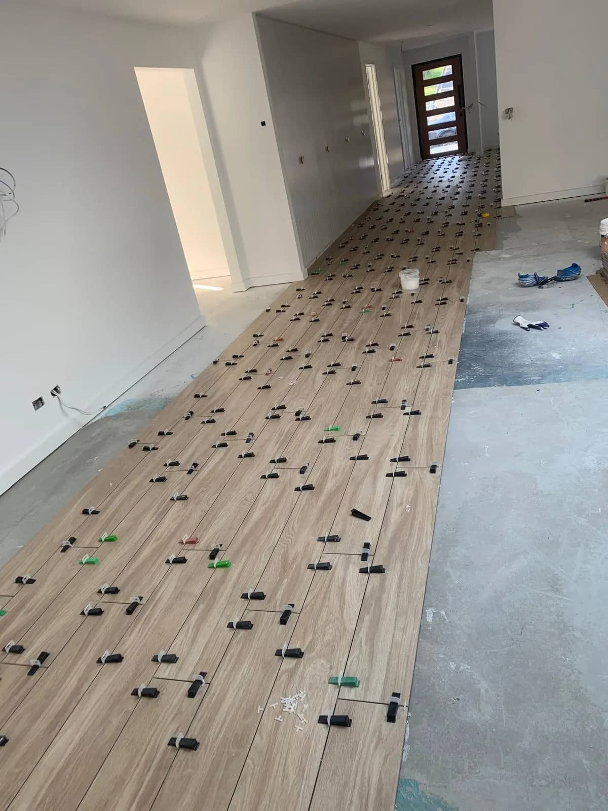 Large format floor tile leveling and installation